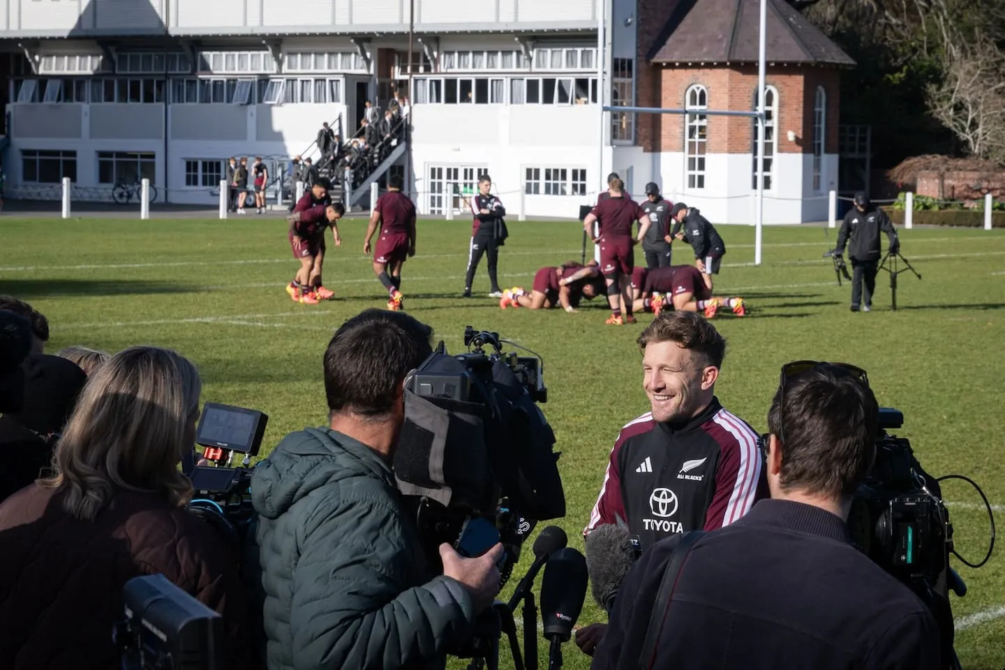 Damian McKenzie talks to the media as the All Blacks forwards get on with training. Photo / Anna Heath