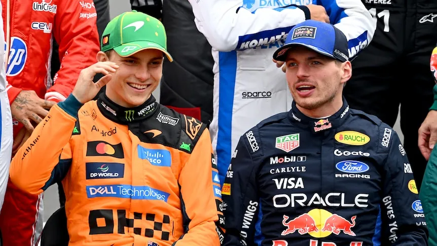 Oscar Piastri and Max Verstappen sitting next to each other during the drivers' photo